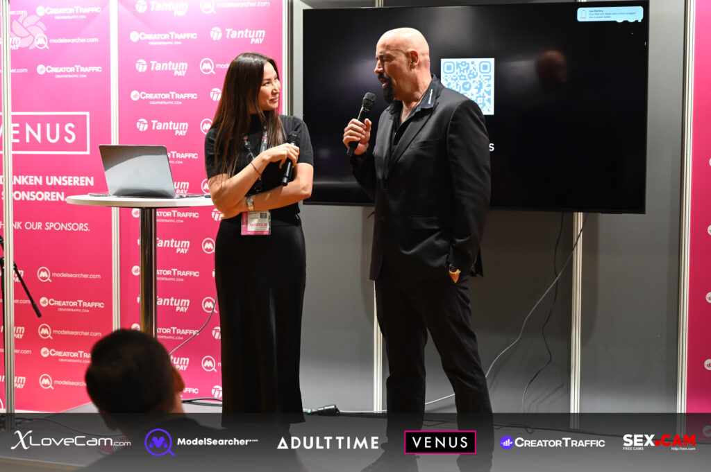 Woman and men talking for a lecture at Venus Berlin 2025